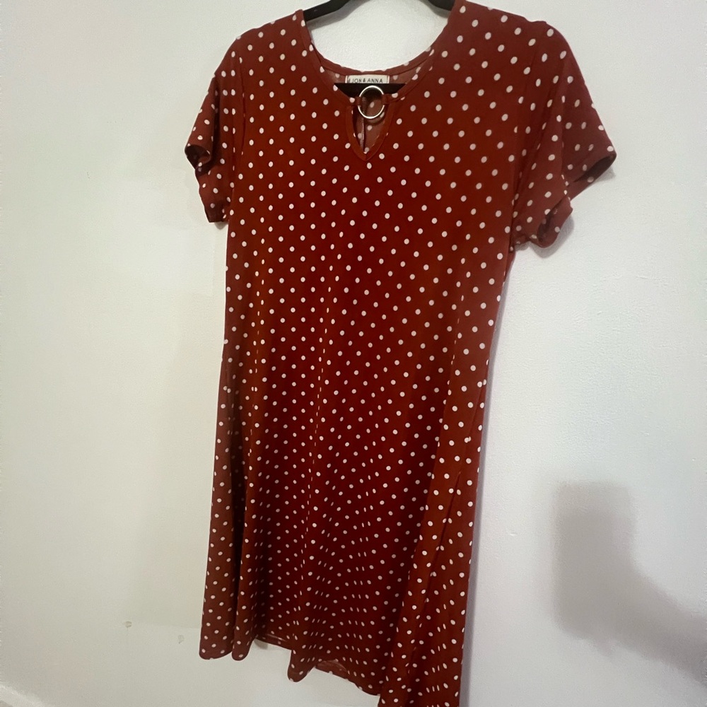 Burnt orange spandex like dress with cream polkadots and a gold embellishment